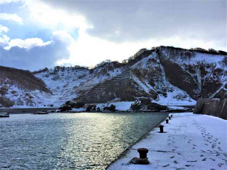 日当たらない残雪残る漁港